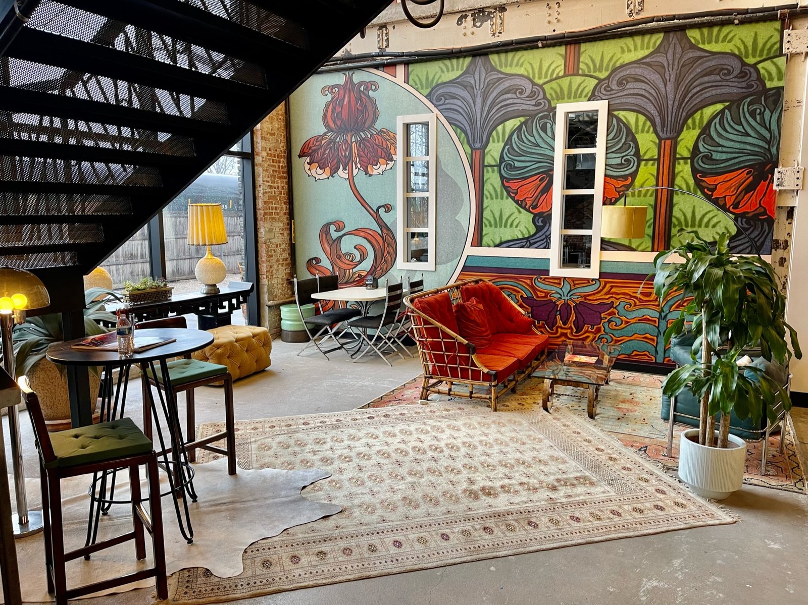 Colorful wall mural and vintage seating in a WOMPA lounge